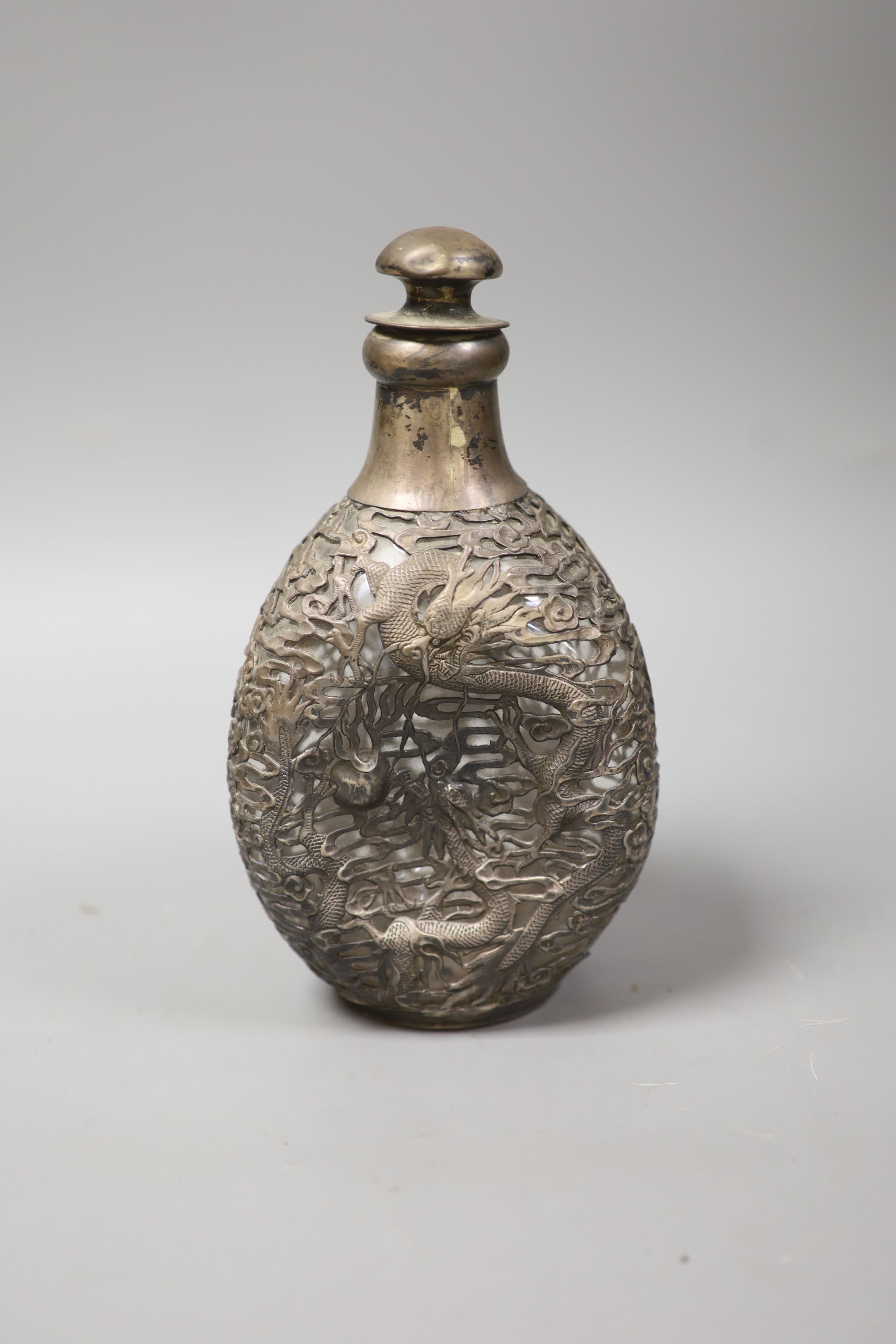 A Chinese pierced white metal mounted dimpled decanter with stopper